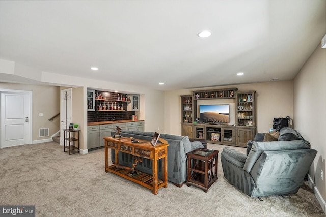 living room with a bar, recessed lighting, baseboards, and visible vents