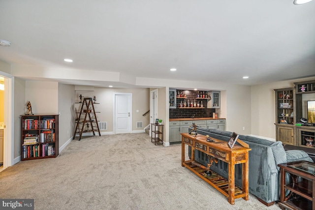living room with recessed lighting, a dry bar, and carpet flooring