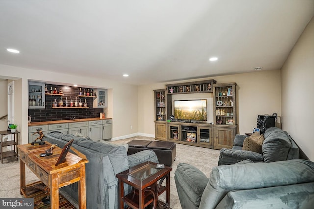 living room featuring indoor bar, recessed lighting, and light colored carpet