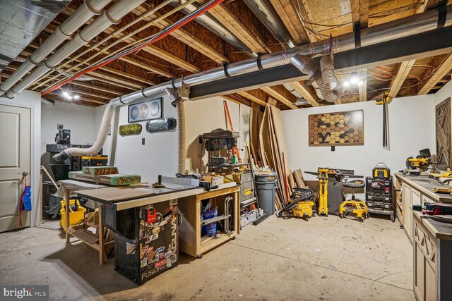 unfinished basement featuring a workshop area