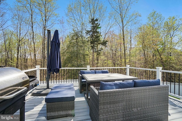 wooden terrace with an outdoor living space