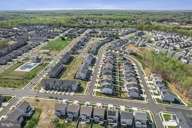 birds eye view of property with a wooded view and a residential view