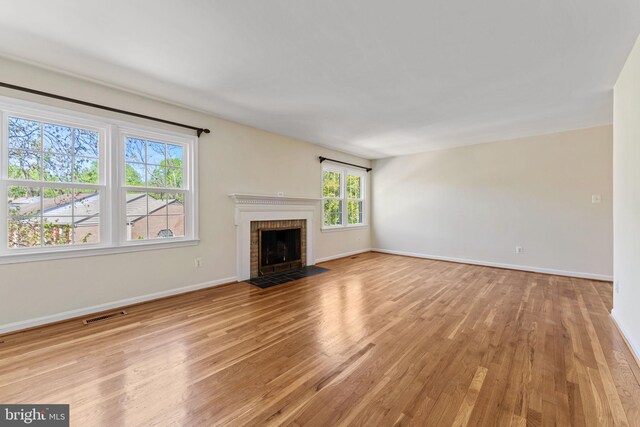 unfurnished living room featuring light wood-style floors, baseboards, and visible vents