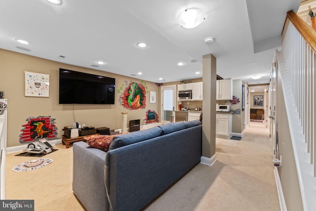 living room with baseboards, recessed lighting, and light carpet