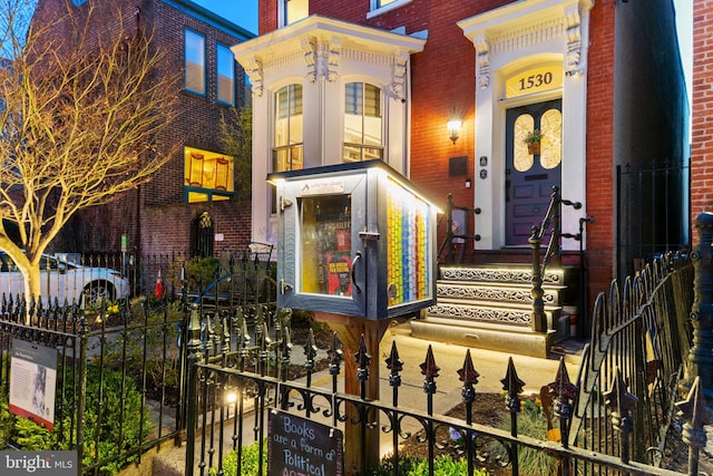 exterior space featuring brick siding and fence