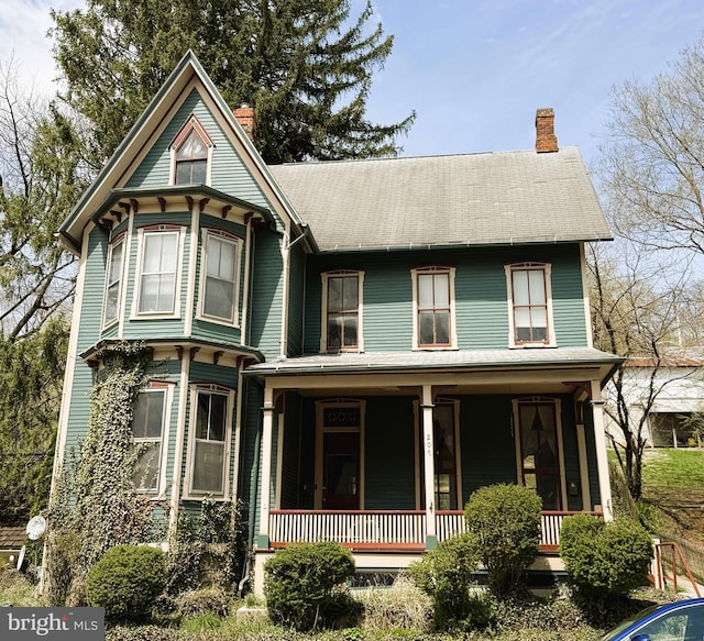 207 E Howard St, Bellefonte, PA 16823 - victorian-style house featuring a chimney and covered porch