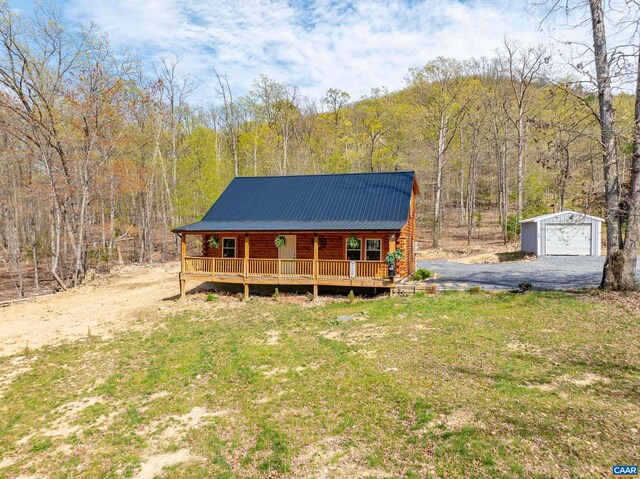 136 Wildwood Ln, Shenandoah, VA 22849 - log home with a wooded view, metal roof, covered porch, an outdoor structure, and log siding