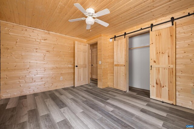 136 Wildwood Ln, Shenandoah, VA 22849 - unfurnished bedroom featuring wood ceiling, wood finished floors, wood walls, and a barn door