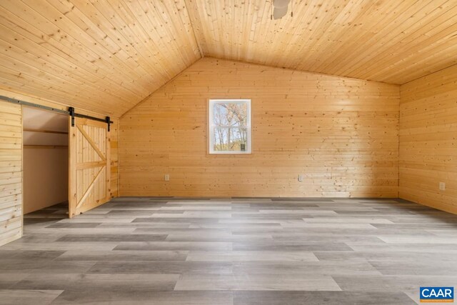 136 Wildwood Ln, Shenandoah, VA 22849 - bonus room featuring wood finished floors, wood walls, lofted ceiling, and a barn door
