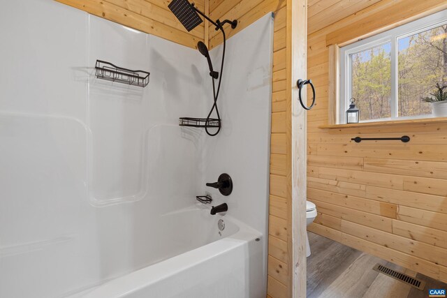 136 Wildwood Ln, Shenandoah, VA 22849 - bathroom featuring visible vents, toilet, wooden walls, wood finished floors, and bathing tub / shower combination