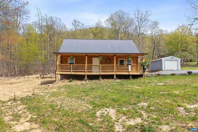 136 Wildwood Ln, Shenandoah, VA 22849 - view of front of home featuring log siding, a porch, a detached garage, and an outbuilding