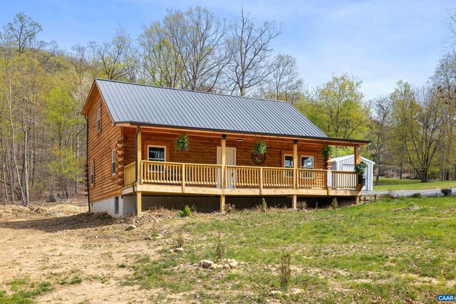 136 Wildwood Ln, Shenandoah, VA 22849 - view of front of home with a wooded view, metal roof, covered porch, and log exterior