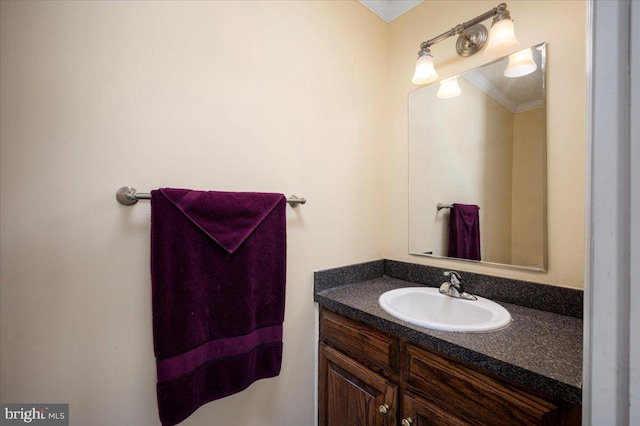 bathroom with ornamental molding and vanity