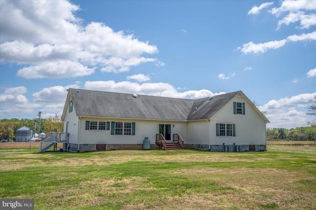 rear view of house with a yard, roof with shingles, crawl space, and central AC