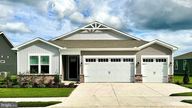 craftsman-style home with an attached garage, a shingled roof, stone siding, and concrete driveway