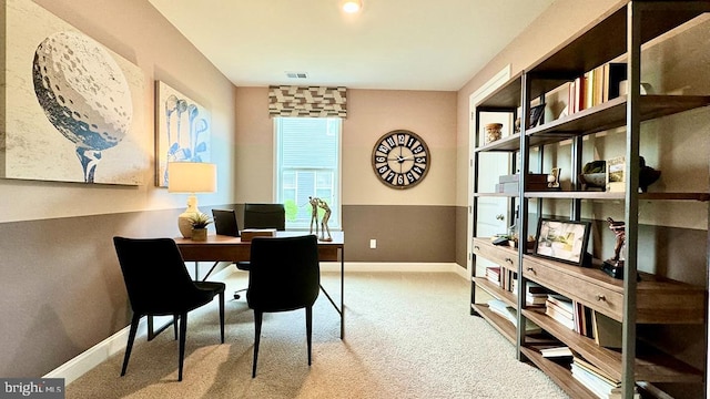 carpeted office space featuring baseboards and visible vents