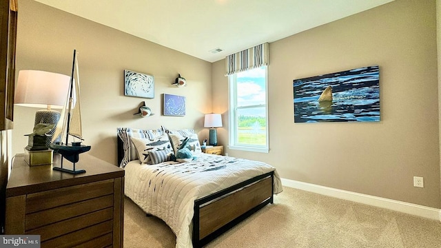 carpeted bedroom with baseboards and visible vents