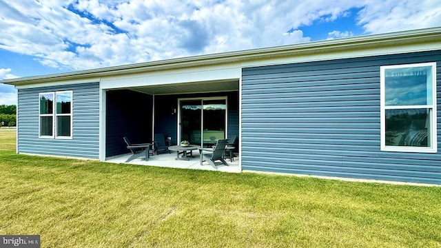 back of property with a patio and a lawn