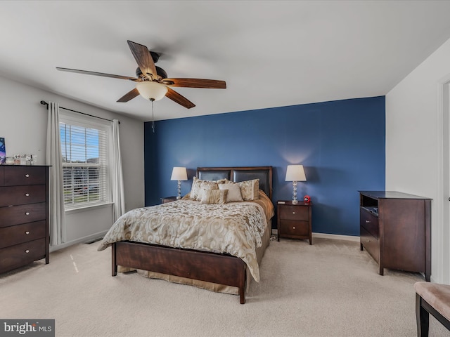 bedroom featuring baseboards, ceiling fan, and light carpet