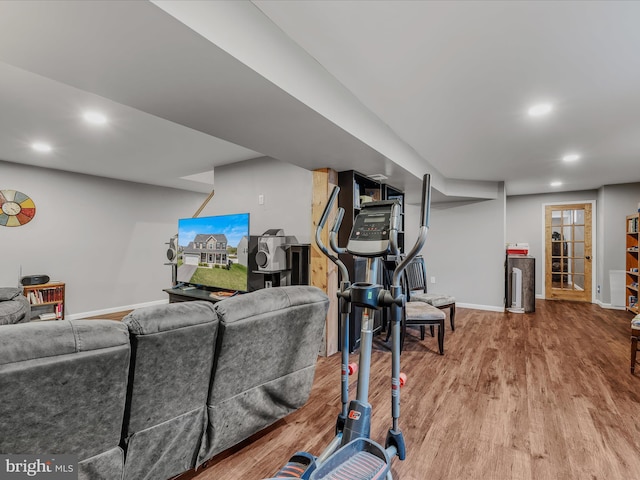 workout area featuring recessed lighting, baseboards, and wood finished floors