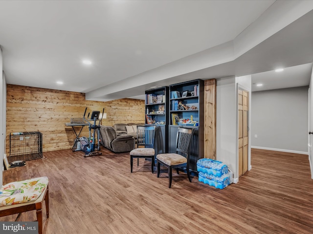 interior space featuring wood walls, recessed lighting, baseboards, and wood finished floors