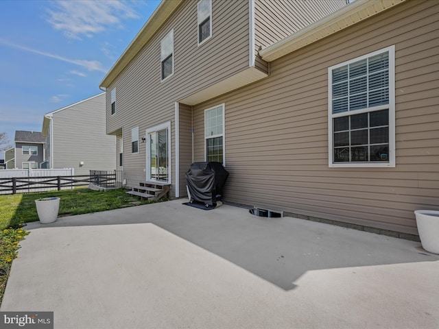 rear view of house featuring a patio, entry steps, and fence