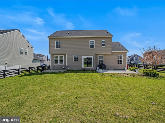 rear view of house featuring a yard, a fenced backyard, and a patio