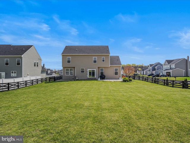 rear view of property with a patio area, a residential view, a fenced backyard, and a lawn