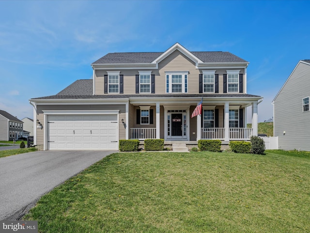 colonial-style house with a front yard, a porch, an attached garage, and driveway