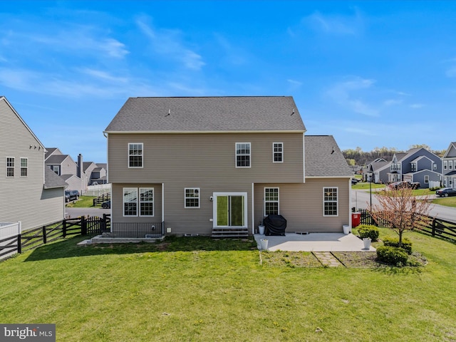 rear view of house featuring a yard, a fenced backyard, a patio, a shingled roof, and a residential view