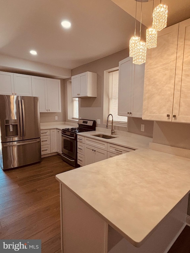 2241 E Preston St, Baltimore, MD 21213 - kitchen featuring stainless steel appliances, a sink, light countertops, white cabinets, and a peninsula