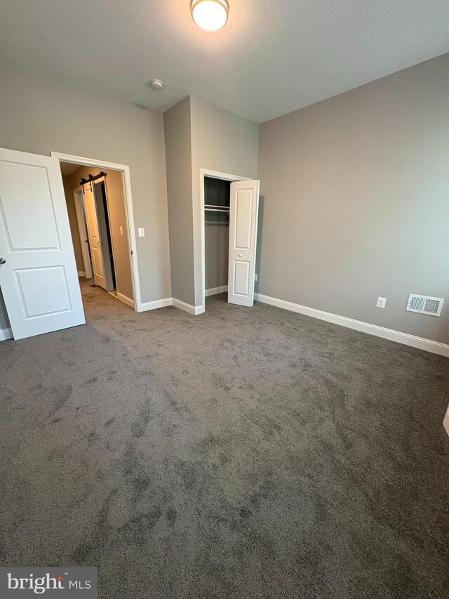 2241 E Preston St, Baltimore, MD 21213 - unfurnished bedroom featuring a closet, baseboards, and carpet floors