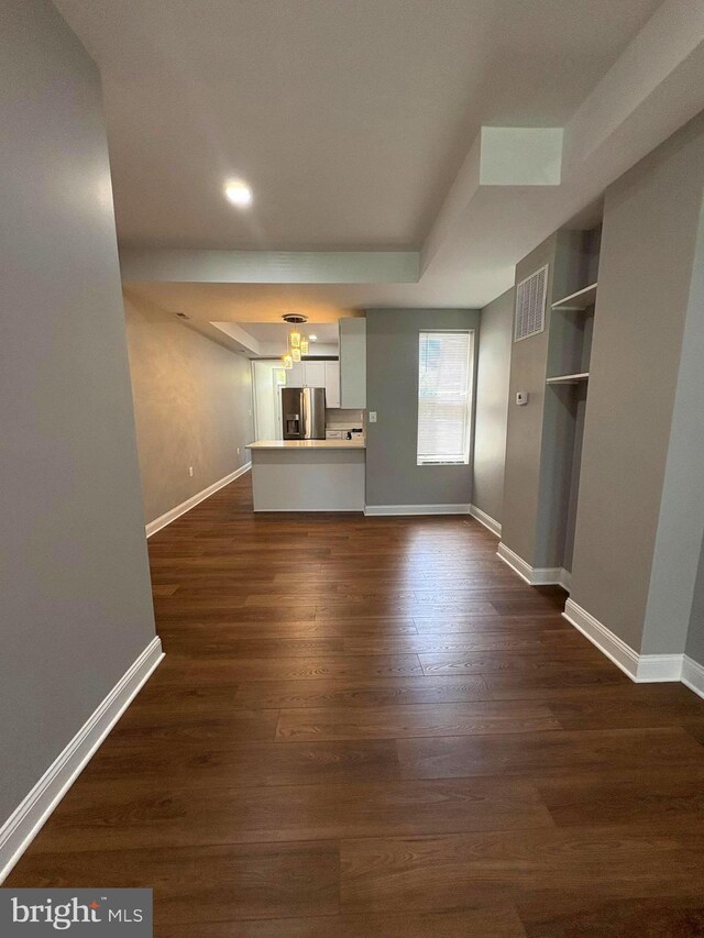 2241 E Preston St, Baltimore, MD 21213 - unfurnished living room with baseboards, dark wood-type flooring, and recessed lighting