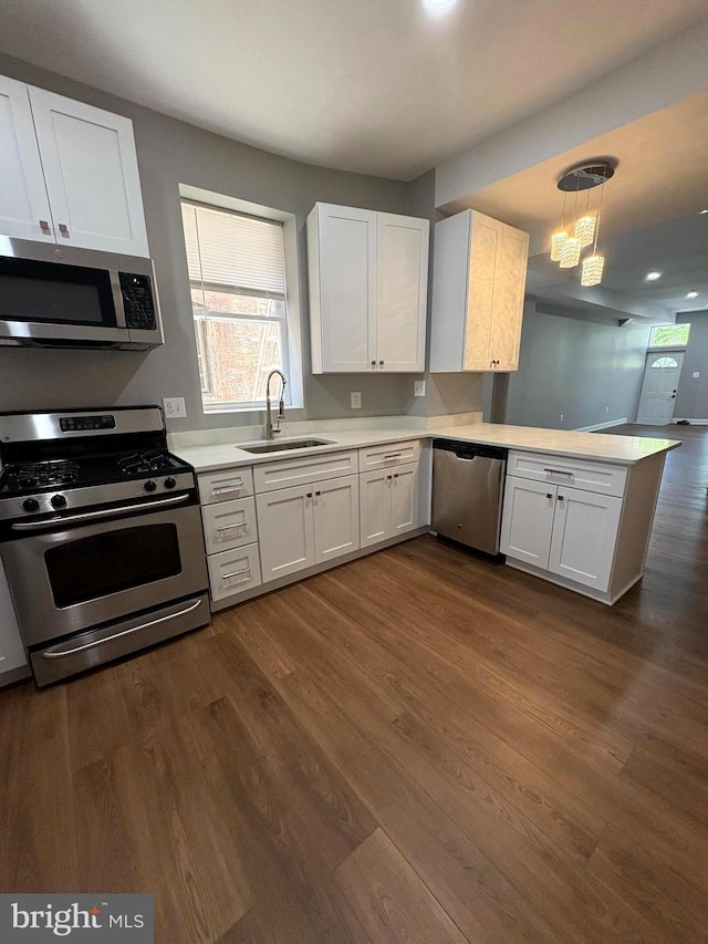 2241 E Preston St, Baltimore, MD 21213 - kitchen featuring stainless steel appliances, a sink, a peninsula, light countertops, and white cabinets