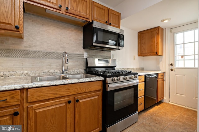 206 Paris Ave, Brooklawn, NJ 08030 - kitchen featuring tasteful backsplash, light tile patterned floors, brown cabinets, stainless steel appliances, and a sink