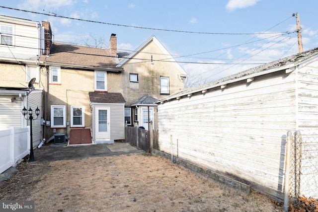 206 Paris Ave, Brooklawn, NJ 08030 - rear view of property with central air condition unit, stucco siding, fence, a chimney, and a shingled roof