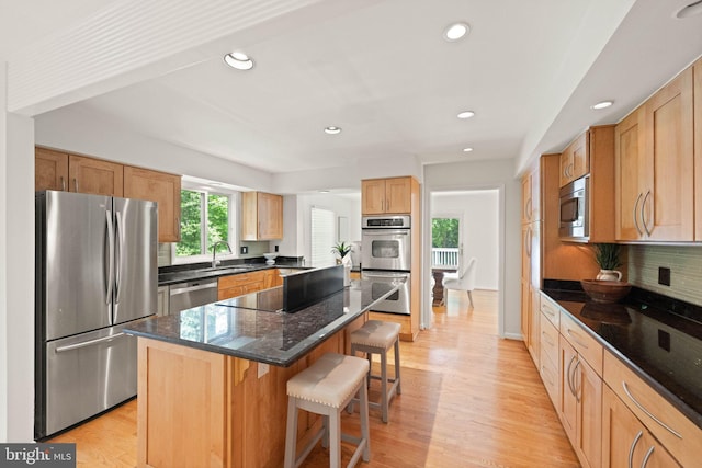 1925 Upper Lake Dr, Reston, VA 20191 - kitchen with appliances with stainless steel finishes, a breakfast bar, a sink, recessed lighting, and light wood finished floors