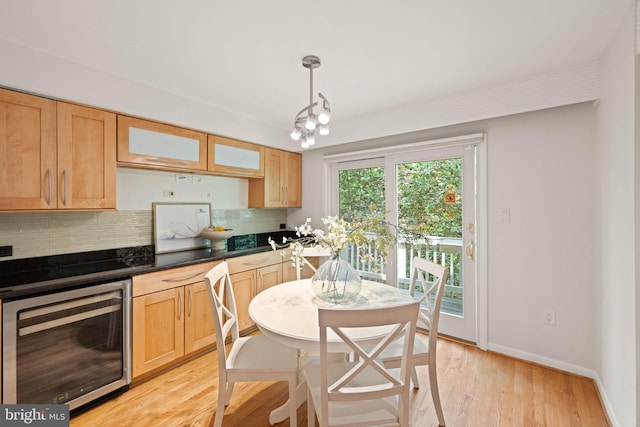 1925 Upper Lake Dr, Reston, VA 20191 - kitchen featuring wine cooler, tasteful backsplash, light wood-type flooring, dark countertops, and glass insert cabinets