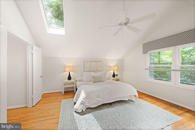 1925 Upper Lake Dr, Reston, VA 20191 - bedroom featuring vaulted ceiling, light wood-type flooring, baseboards, a skylight, and a ceiling fan