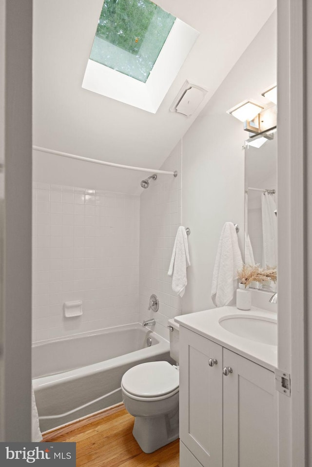 1925 Upper Lake Dr, Reston, VA 20191 - bathroom featuring a skylight, lofted ceiling, toilet, vanity, and wood finished floors