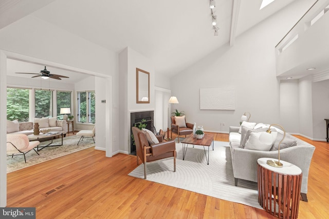 1925 Upper Lake Dr, Reston, VA 20191 - living room featuring high vaulted ceiling, wood finished floors, a ceiling fan, baseboards, and a fireplace