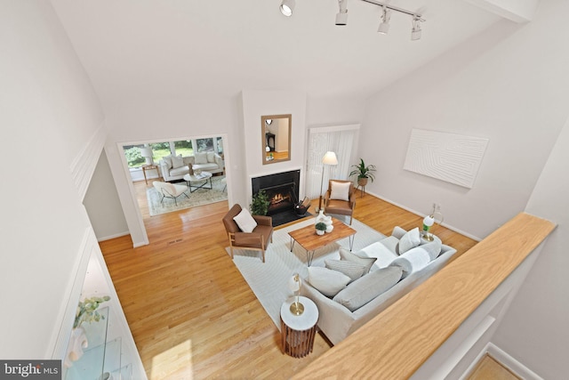 1925 Upper Lake Dr, Reston, VA 20191 - living room featuring a warm lit fireplace, wood finished floors, and baseboards