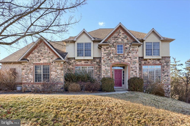 704 Goddard Dr, York, PA 17402 - traditional home featuring a shingled roof, a front yard, stone siding, and stucco siding