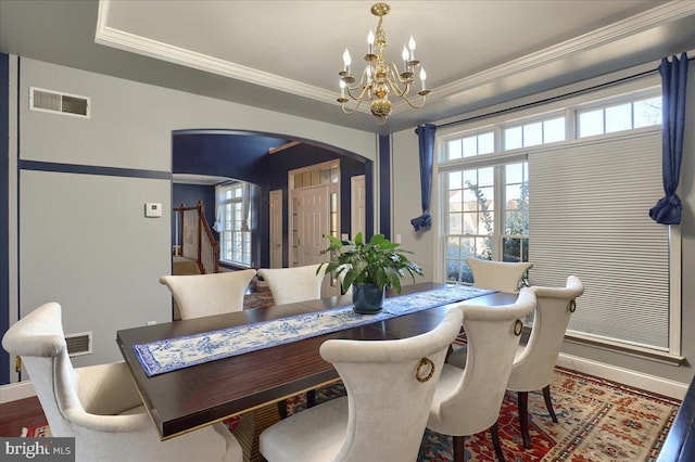 704 Goddard Dr, York, PA 17402 - dining area featuring visible vents, arched walkways, an inviting chandelier, and plenty of natural light