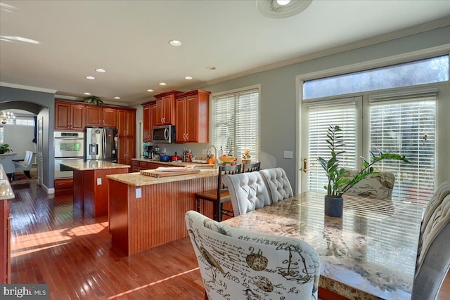 704 Goddard Dr, York, PA 17402 - kitchen featuring crown molding, a kitchen island, light stone countertops, and stainless steel appliances