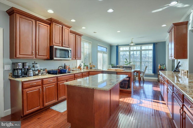 704 Goddard Dr, York, PA 17402 - kitchen featuring ornamental molding, a peninsula, dark wood-style floors, stainless steel microwave, and recessed lighting