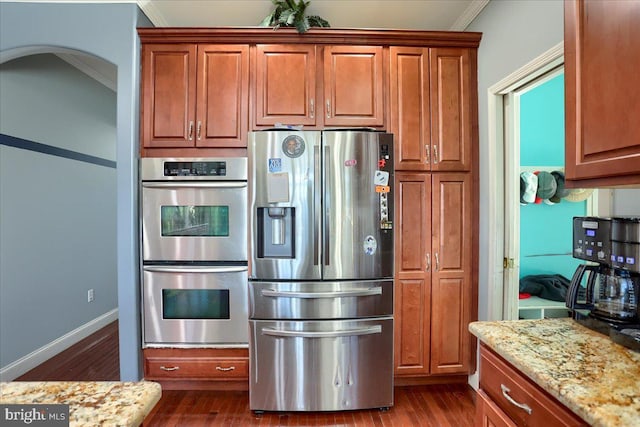 704 Goddard Dr, York, PA 17402 - kitchen with stainless steel appliances, light stone countertops, dark wood-style floors, and ornamental molding