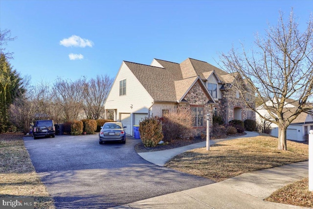 704 Goddard Dr, York, PA 17402 - view of side of home with stone siding, a garage, and driveway