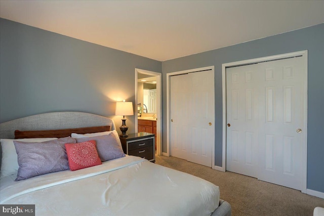 704 Goddard Dr, York, PA 17402 - bedroom featuring baseboards, two closets, and light carpet