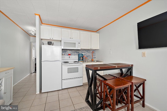 kitchen featuring white cabinetry, decorative backsplash, crown molding, and white appliances